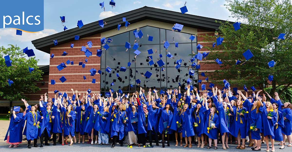 Graduation, student's cap toss, blue graduation cap and gowns