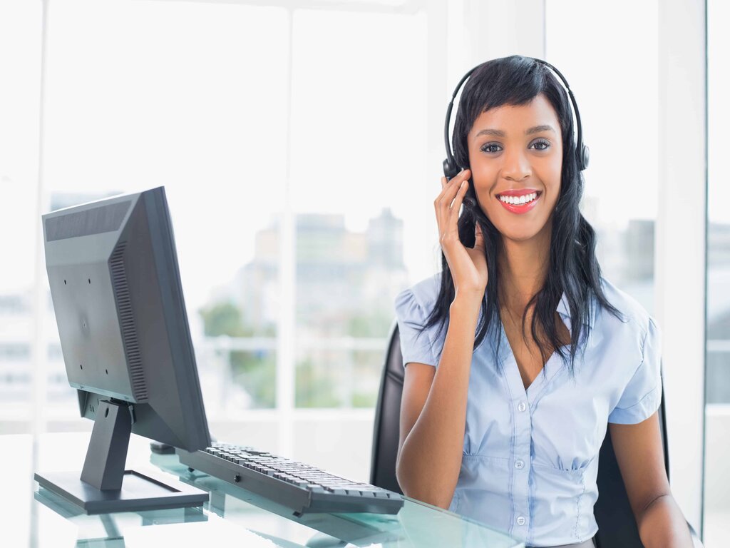 Woman with headset on computer for online information session